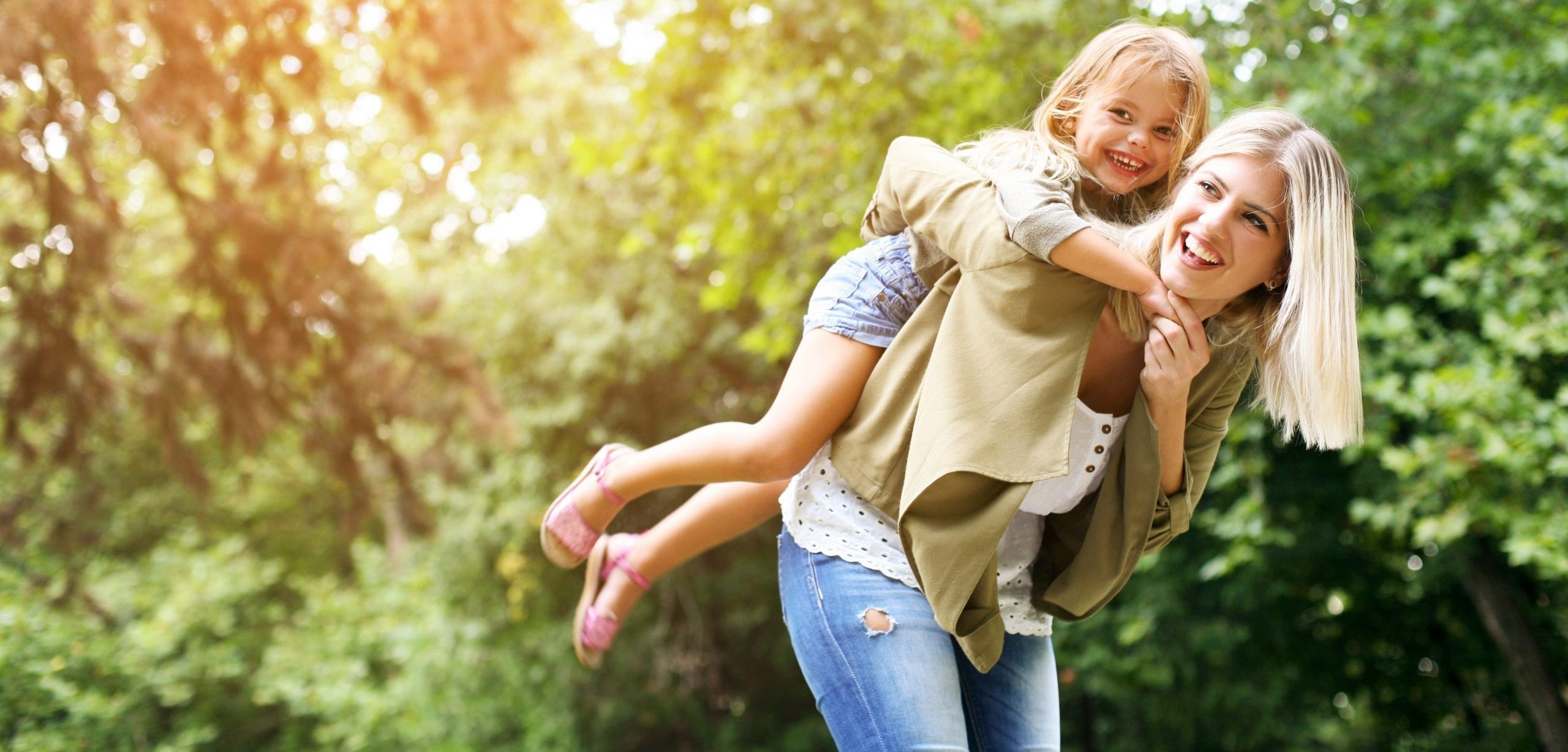 Mother carrying daughter on her back